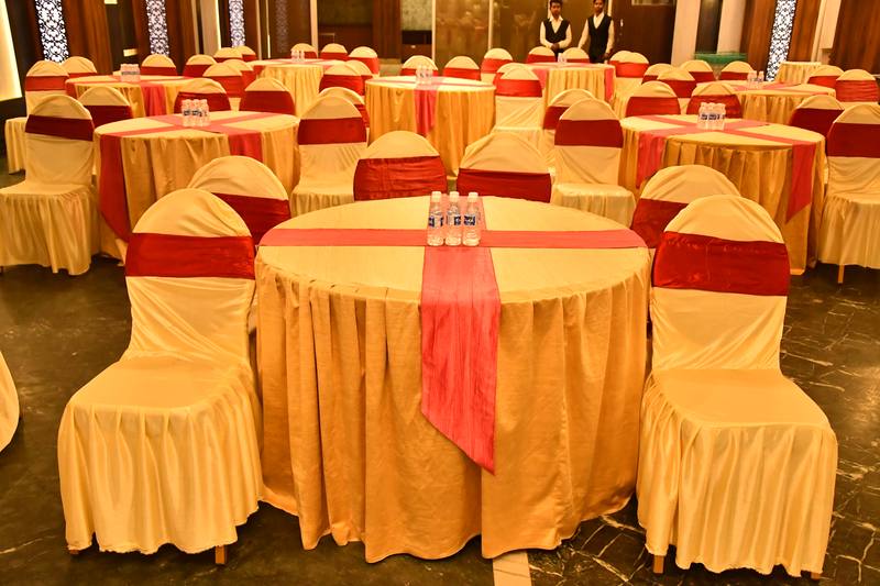 Gold and red table setting at Maya