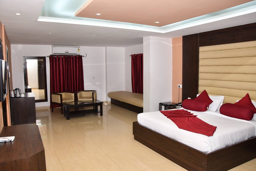 Executive Room at Chinmaye Inn — king bed with sitting corner